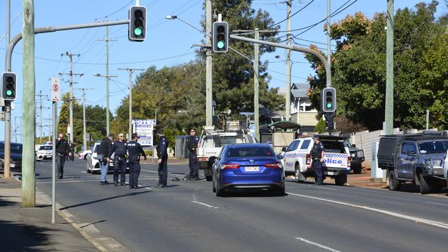 Two men have been arrested after they allegedly carjacked an electrician in Dalby and shot him in the groin and led police on a chase to Toowoomba in a stolen Mitsubishi Triton ute. They were arrested at the corner of West Street and O'Quinn Street, about 10am, May 11, 2023.