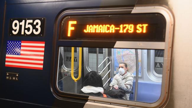 A woman with a face mask rides the subway. Picture: Angela Weiss / AFP)