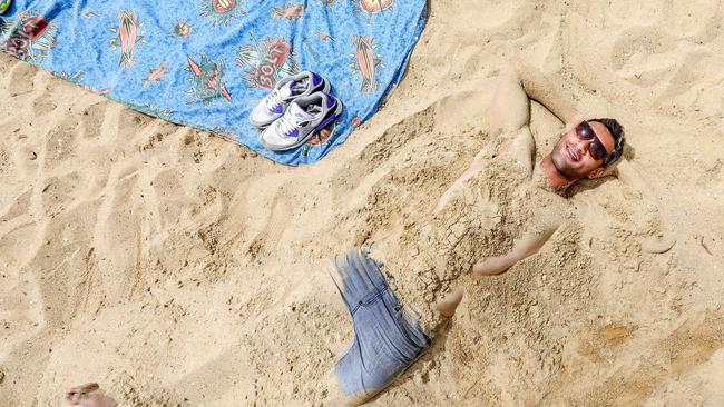 Josh, 30 enjoying warm weather on St Kilda beach earlier this week. Picture Tim Carrafa