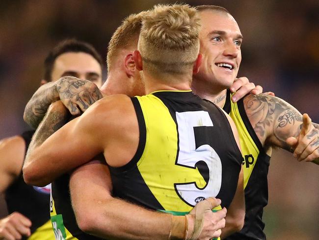 MELBOURNE, AUSTRALIA - MAY 19:  Dustin Martin of the Tigers celebrates with his teammates after a goal  during the round nine AFL match between the Richmond Tigers and the Hawthorn Hawks at Melbourne Cricket Ground on May 19, 2019 in Melbourne, Australia. (Photo by Scott Barbour/Getty Images)