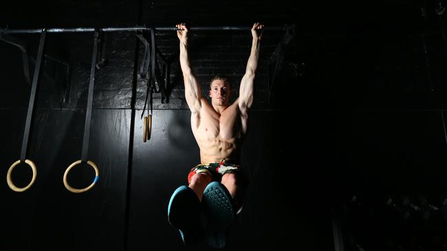James Newbury working his core at CrossFit Gym in the city. Photo: Tait Schmaal.