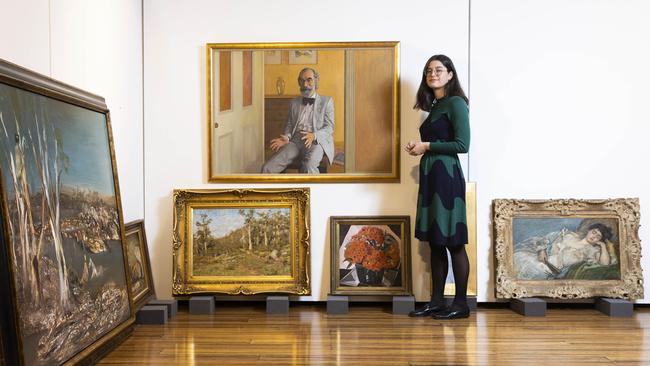 Eliza Burton, of Deutscher and Hackett, with the portrait of Joseph Brown by Brian Dunlop being auctioned by super fund Cbus. Picture: Aaron Francis