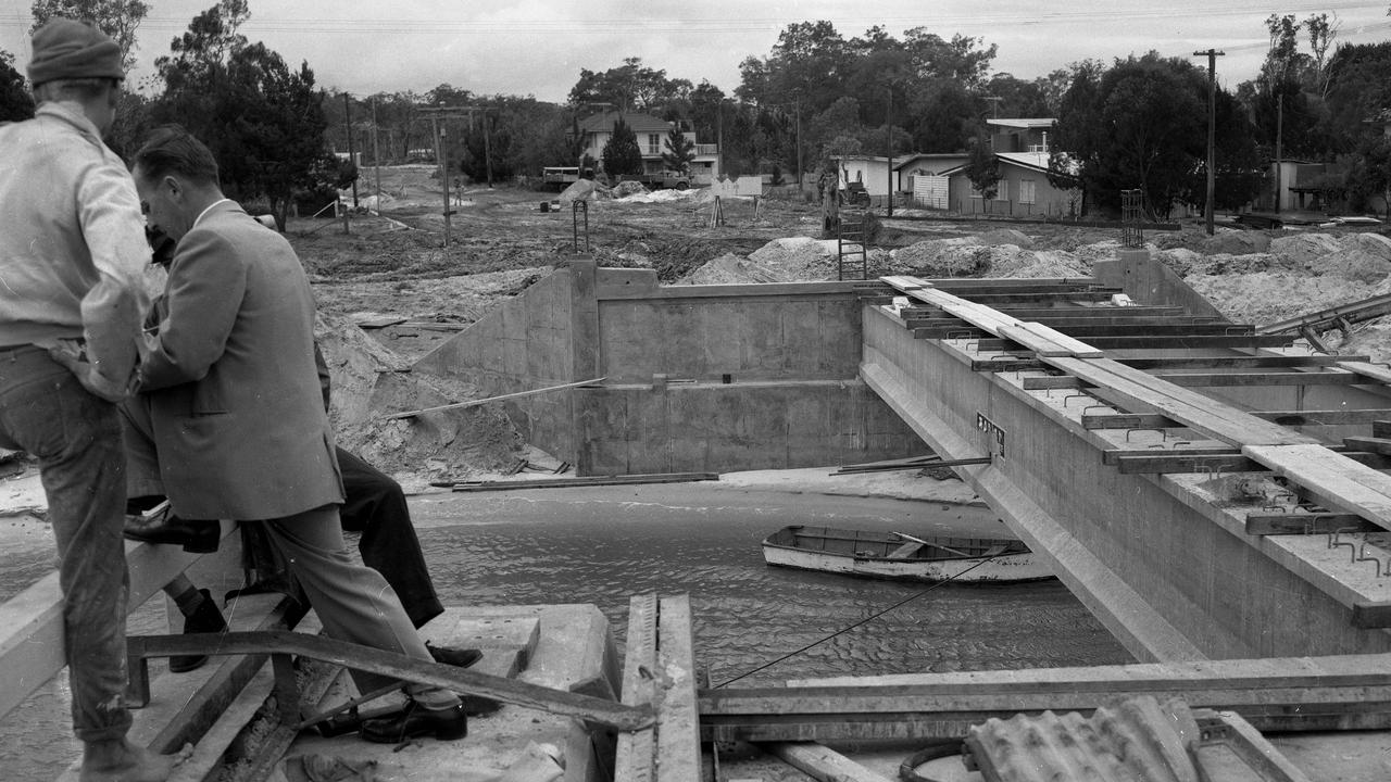 8/8/1963. Investigators start probing the cause of an industrial accident during construction of the Bribie Island bridge, north of Brisbane. A crane’s mechanism failed as a bearer was being lifted into place on the Bribie end of the bridge, allowing the 22m pre-stressed concrete bearer to crash into the water. Picture by Ray Saunders.