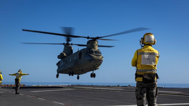 Aviation Support Sailors from the Australian Amphibious Force guide a CH-47 Chinook as it conducts deck landing qualifications on HMAS Adelaide. Photo: CPL Michael Rogers