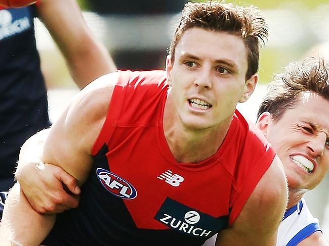 HOBART, AUSTRALIA - FEBRUARY 24:  Jake Lever of the Demons handballs from Ben Jacobs of the Kangaroos during the JLT Community Series AFL match between the North Melbourne Kangaroos and the Melbourne Demons at Blundstone Arena on February 24, 2018 in Hobart, Australia.  (Photo by Michael Dodge/Getty Images)