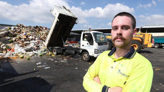 Connor Ryan of Young Civil helping remove the flood-damaged produce at Brisbane Markets, Rocklea. Picture: Liam Kidston.