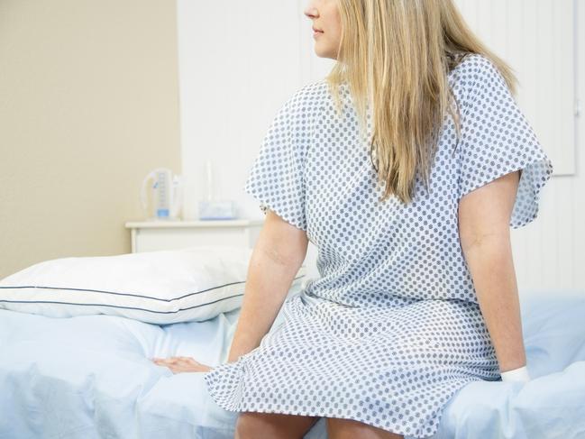 Mid-adult woman in gynecologist's office for her annual check up.  Women's health concept.