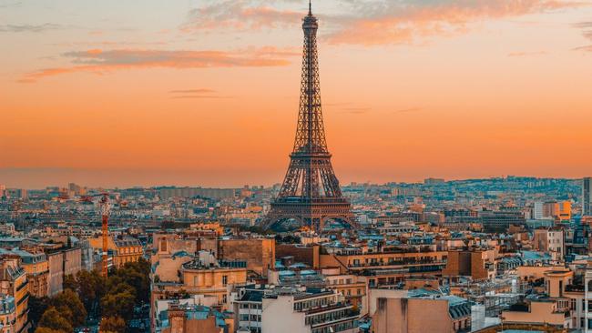 The Eiffel Tower and Paris skyline at sunset.