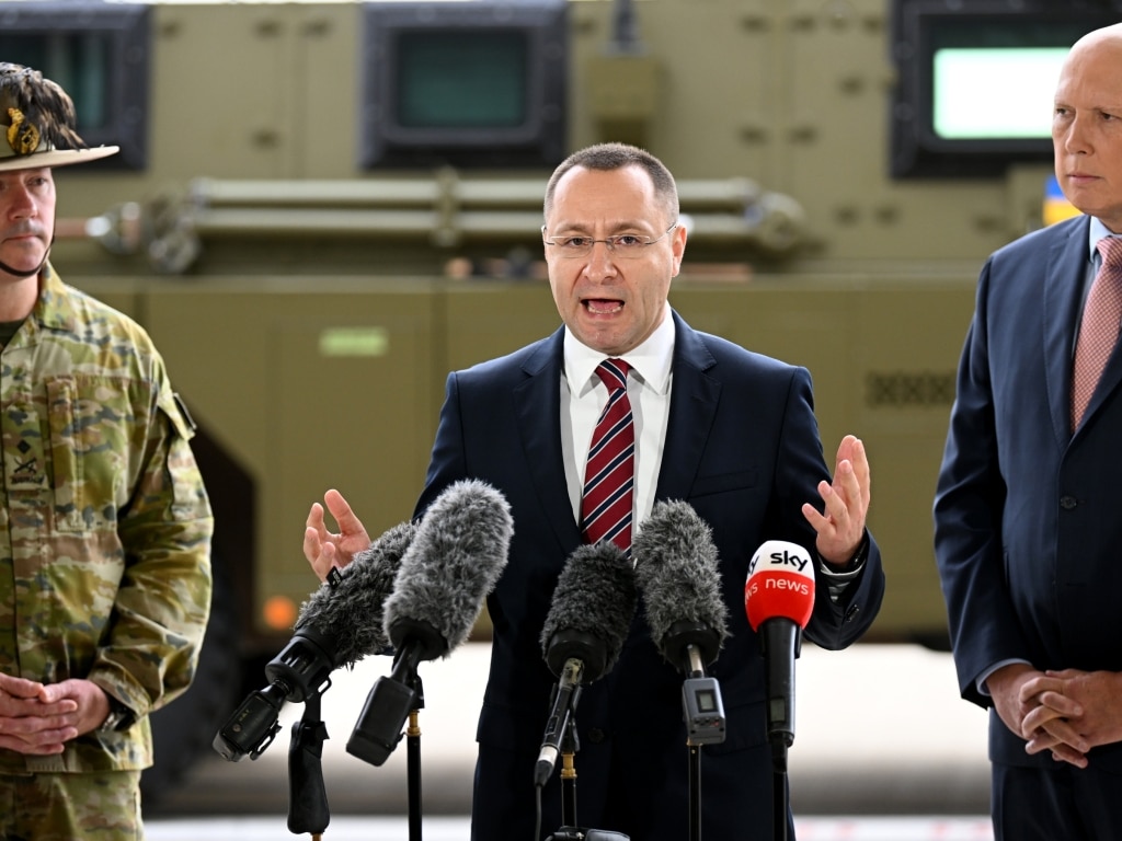 IPSWICH, AUSTRALIA - APRIL 08: Ambassador of Ukraine to Australia Vasyl Myroshnychenko (C), joined by Australian Defence minister Peter Dutton (R), speaks during a press conference at the Amberley Air Base on April 08, 2022 in Ipswich, Australia. The Australian government is sending a total of 20 Bushmaster Protected Mobility Vehicles to Ukraine following a direct request for assistance by Ukrainian President Volodymyr Zelenskyy during his virtual address to the Australian parliament last Thursday. (Photo by Dan Peled/Getty Images)