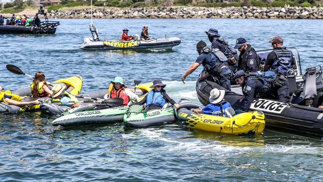 NSW Police stop climate protesters who paddle out to the shipping channel during the People's Blockade. Picture: Roni Bintang