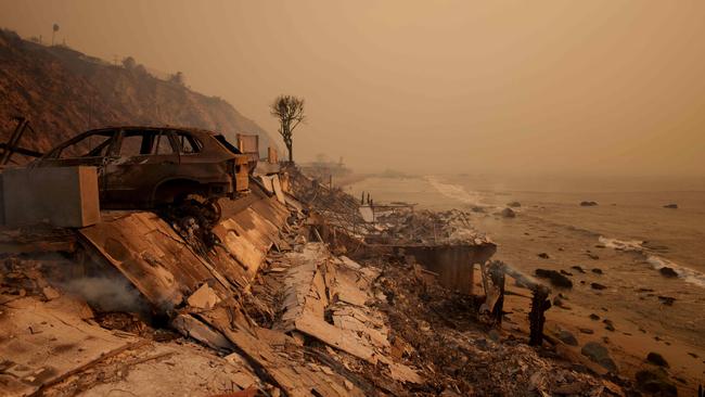 A burned car sits next to the remains of a home destroyed during the Palisades Fire. Picture: AFP