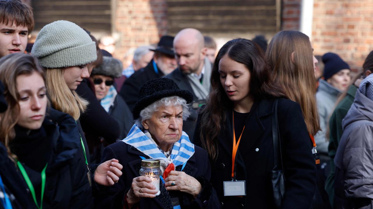 Survivors, relatives and representatives of the Memorial and Museum Auschwitz-Birkenau lay wreaths and light candles. Picture: AFP