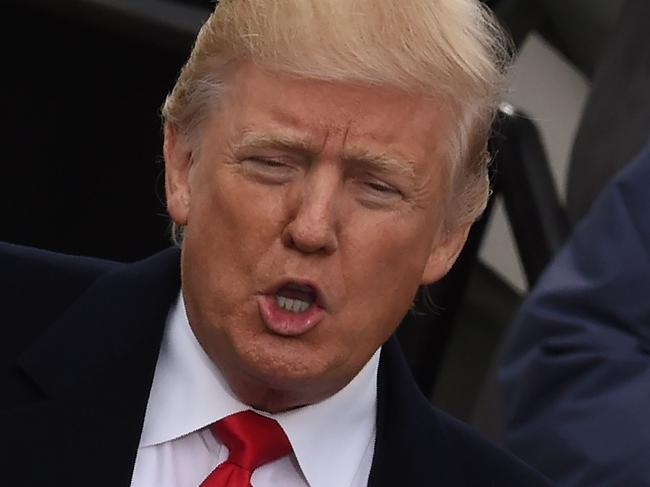 (FILES) Donald Trump (L) is sworn in as the 45th US president by Supreme Court Chief Justice John Roberts in front of the Capitol in Washington on January 20, 2017.  While the new US president has shown a capacity to change, both his tone and his positions, he has been unable to show the world a "new" Trump, with a steady presidential style and a clearly articulated worldview. As the symbolic milestone of his 100th day in power, which falls on April 29, 2017, draws near, a cold, hard reality is setting in for the billionaire businessman who promised Americans he would "win, win, win" for them. At this stage of his presidency, he is the least popular US leader in modern history (even if his core supporters are still totally behind him.) / AFP PHOTO / Timothy A. CLARY / TO GO WITH AFP STORY, US-politics-Trump-100days