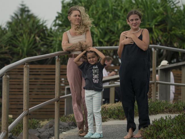 Carlie Fairburn and daughters Sahni and Yemayah Chopen take in the scene at 7 Mile Beach at Lennox Head, just down the road from Byron, as the community braces ahead of TC Alfred. Picture: NewsWire / Glenn Campbell