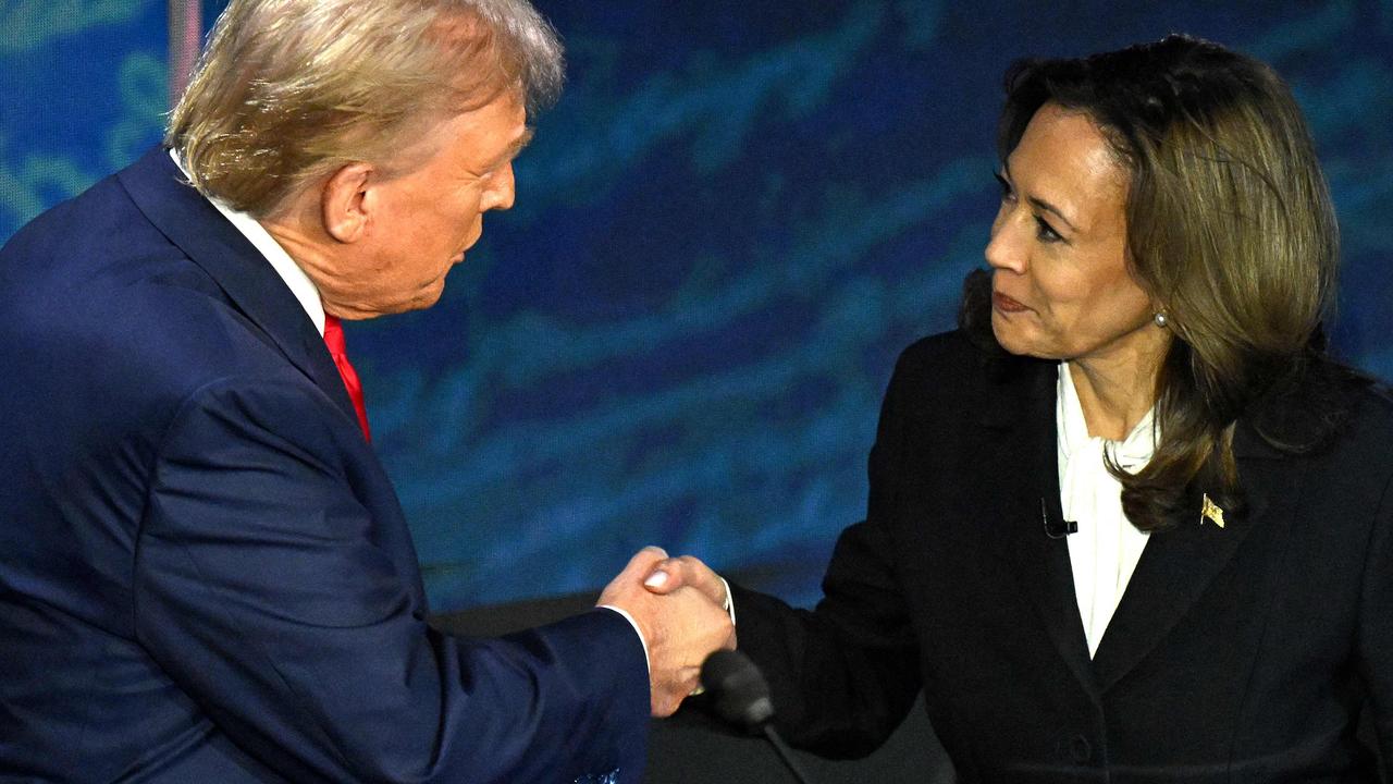 The two candidates shake hands before the start of the debate. Picture: Saul Loeb/AFP