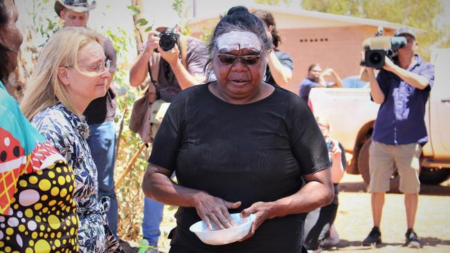 Kumanjayi Walker's mother Leanne Oldfield paints Territory Coroner Elisabeth Armitage’s forehead in Yuendumu last year. Picture: Jason Walls