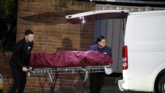 The body of a 19 year old woman being removed from a unit on Hardy Street. Picture: Jonathan Ng