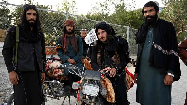 Taliban fighters stand along a road in Kabul. Picture: AFP