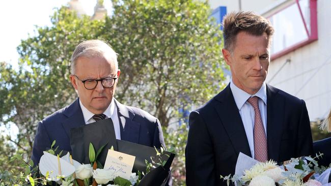 Prime Minister Anthony Albanese and NSW Premier Chris Minns lay flowers at the tribute area at Bondi Junction for the victims of Saturday’s stabbing attacks. Picture: Damian Shaw