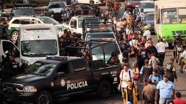 Forensic investigators work at the crime scene of the killing of Jose Munoz and Ximena Guzman in Mexico City. Picture: AFP.