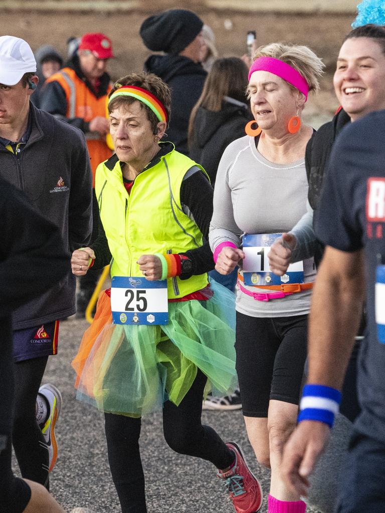 Members of the Awesome Toowoomba Road Runners Ladies (centre) Chris Hazel and Chris Gillett with the runners at the start of the 40 for Fortey relay. Picture: Kevin Farmer