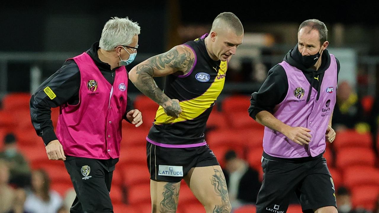 Dustin Martin is helped off the ground after being injured. Picture: Russell Freeman
