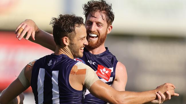 Fremantle’s James Aish and Reece Conca of the Dockers celebrate a goal during their Marsh Series match against Carlton. Picture: Paul Kane/Getty Images