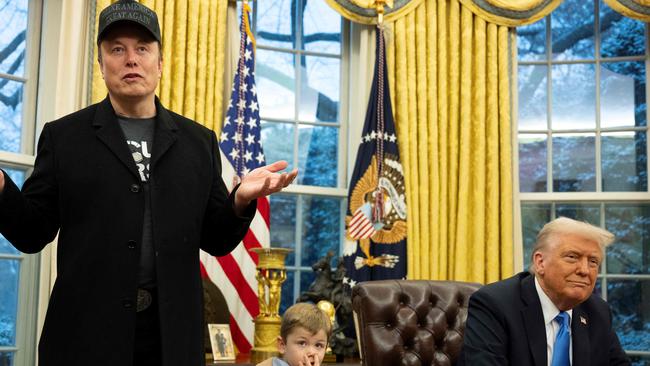 TOPSHOT - Elon Musk speaks as his son X Ã A-Xii and US President Donald Trump look on in the Oval Office of the White House in Washington, DC, on February 11, 2025. Tech billionaire Elon Musk, who has been tapped by President Donald Trump to lead federal cost-cutting efforts, said the United States would go "bankrupt" without budget cuts. Musk leads the efforts under the newly created Department of Government Efficiency (DOGE), and was speaking at the White House with Trump, who has in recent weeks unleashed a flurry of orders aimed at slashing federal spending. (Photo by Jim WATSON / AFP)