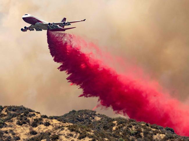 The 747 Supertanker makes a retardant drop on a ridge as firefighters continue to battle the Apple fire near Banning, California. Picture: AFP