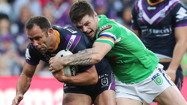 Storm skipper Cameron Smith is tackled by Canberra’s John Bateman. Picture: Michael Klein.