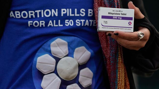 A pro-abortion rights activist holds a box of mifepristone during a rally in front of the US Supreme Court. Picture: AFP