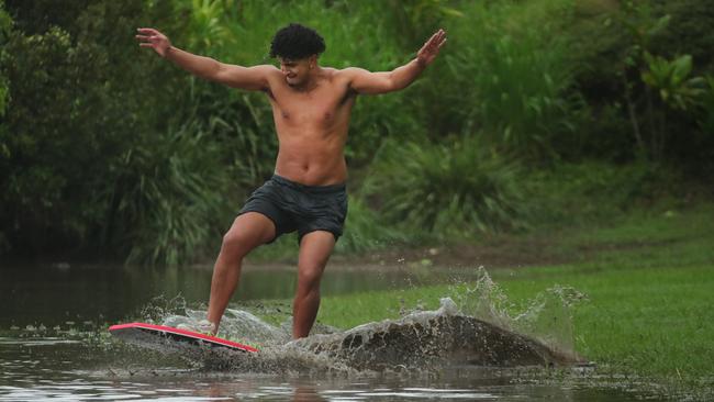 Paeroa Paul has fun in the floodwaters at Flooded Gum Park at Pacific Pines. Picture: Glenn Hampson
