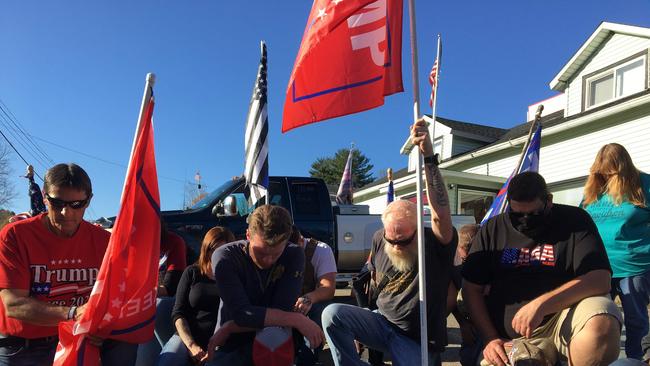 Trump supporters take a knee in Towanda, Pennsylvania. Picture: AFP