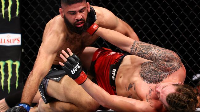 Brendan Allen (right) grapples with Jacob Malkoun in their middleweight bout during UFC 275 at Singapore Indoor Stadium.