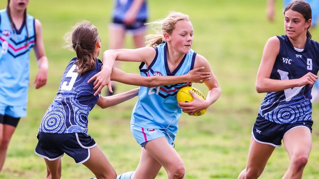 Victoria's Chloe Bilucaglia tackles NSW's Andie Pieper on day two of the School Sport Australia U12 Australian Football Championships at Norwood Oval. Picture: Tom Huntley