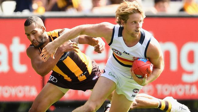 Rory Sloane shrugs a tackle from Josh Gibson.