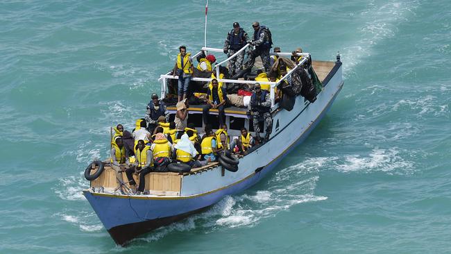 Australian Navy personnel escort a boat containing 40-50 asylum seekers.