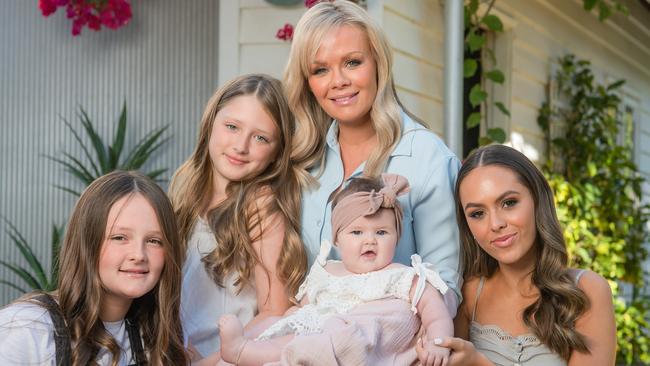 Alex Fevola with daughters Mia, 19, Leni 12, Lulu, 9, and baby Tobi, 5 months at their home in Brighton. Picture: Jason Edwards