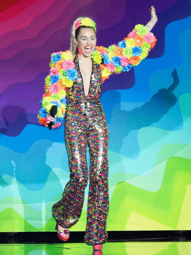 Miley’s neon daisy bolero embellished with Preciosa Crystal Components, whatever they are.