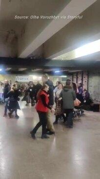 Crowds sheltering from air raids perform traditional folk dances in Kyiv underground station 