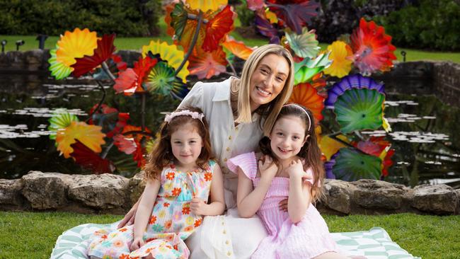 Stephanie Ockenden with her girls Madeline (5) and Annabelle (7) in the Botanic Garden for the Chihuly Garden Cycle exhibition. Picture: Matt Turner