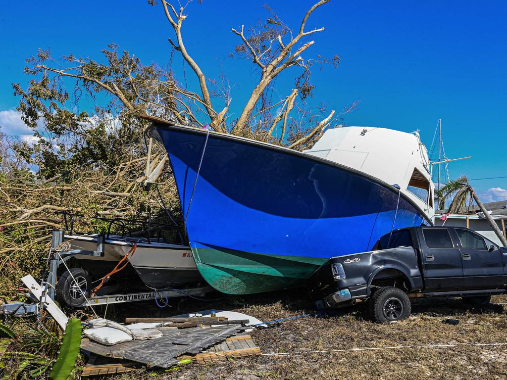 A beached boat sit on top of a pick-up truck in the aftermath of Hurricane Ian in San Carlos Island, Florida. Picture: Giorgio VIERA / AFP