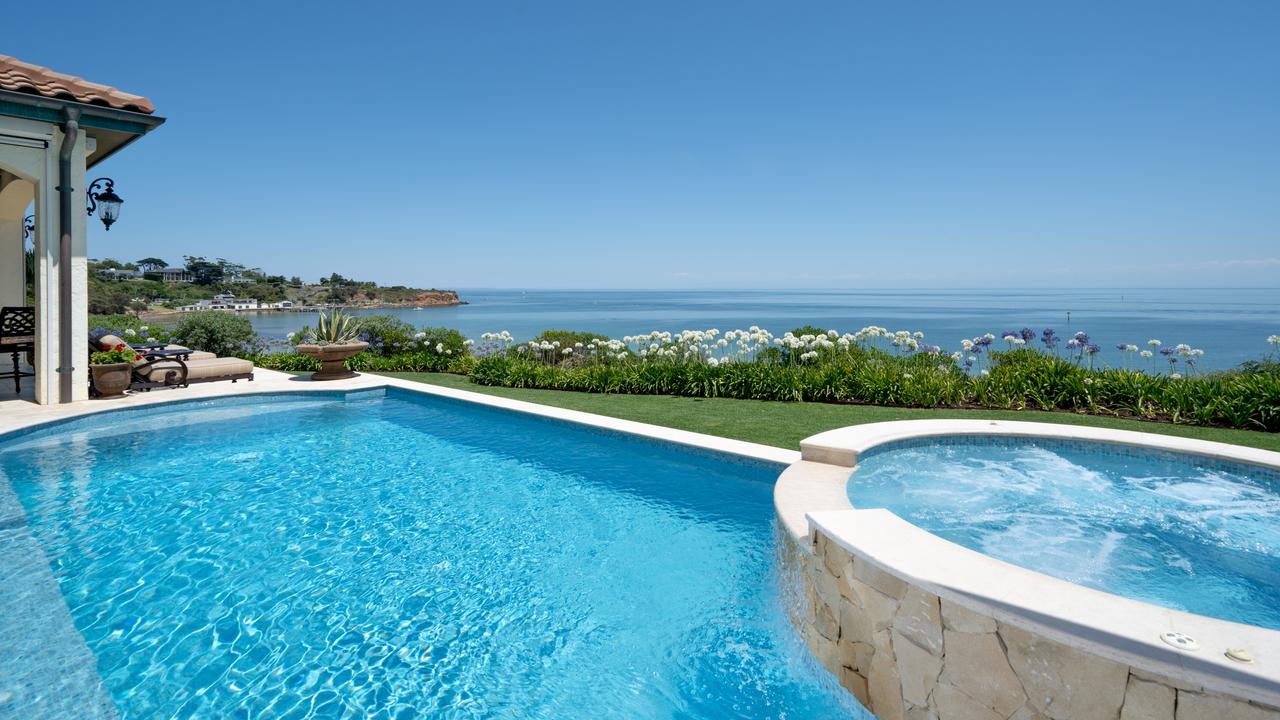 The pool and spa with views of the ocean.