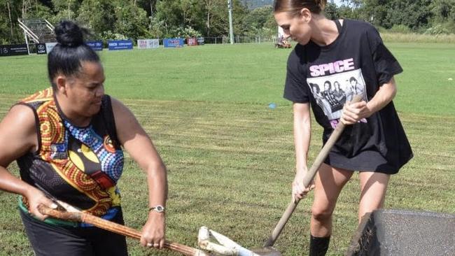 Orara Valley Axemen ladies league tag coach Loretta Donovan and Alex are pitching in to try and restore the field to a playable state.