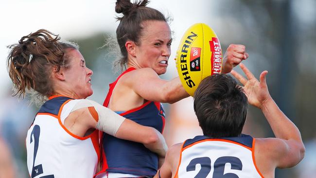 Melbourne captain Daisy Pearce tries to fight her way through the GWS defence.