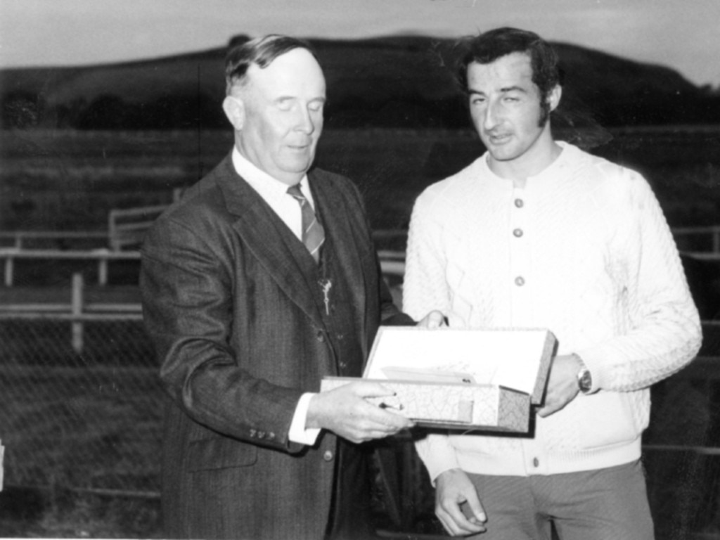 Casterton Racing club president, Kevin Stark presents Rick Renzella with a trophy after the Muntham Handicap.