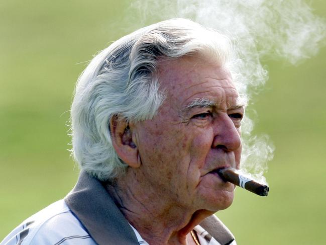 Former PM Bob Hawke enjoys smoking a cigar at celebrity pro am event at the Royal Sydney Golf Course in Sydney.