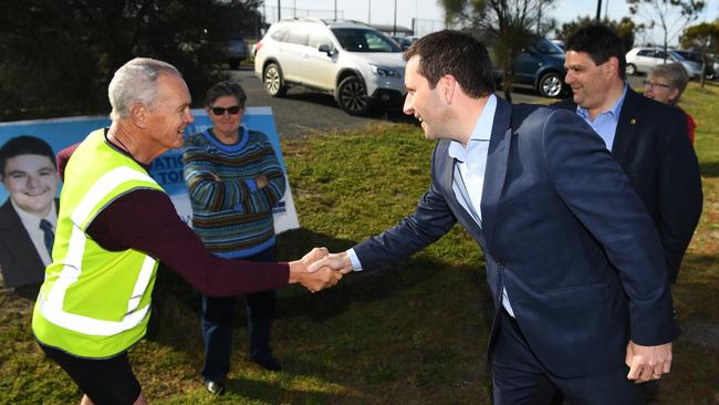 Mr Guy shakes hands with a local resident prior to announcing funding for a proposed aquatic centre in Torquay. Picture: AAP/James Ross