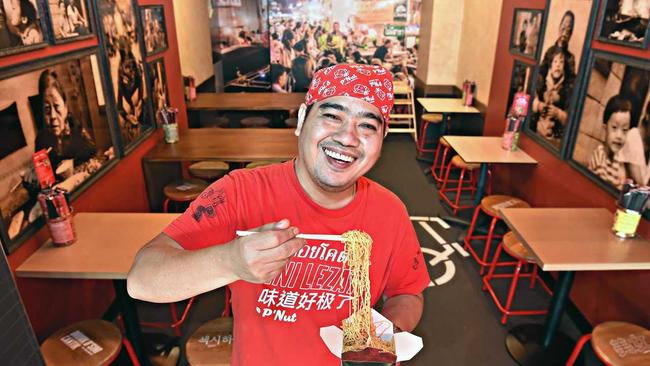 SMILES FOR NOODLES: P&#39;Nut Street Noodles head chef Nut Kunlert with tasty noodles at his restaurant in Kawana Shopping World. Picture: Warren Lynam