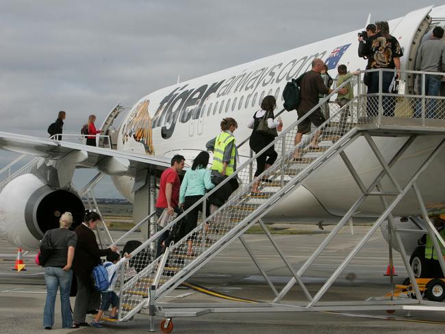 23 Nov 2007 Passangers board the first Tiger flight. Tiger Airways takes off at Melbourne Airport. Flight TT7402 to the /Gold /Coast, it was the first flight to depart from its home of Melbourne Airport. aviation aircraft airlines plane jet